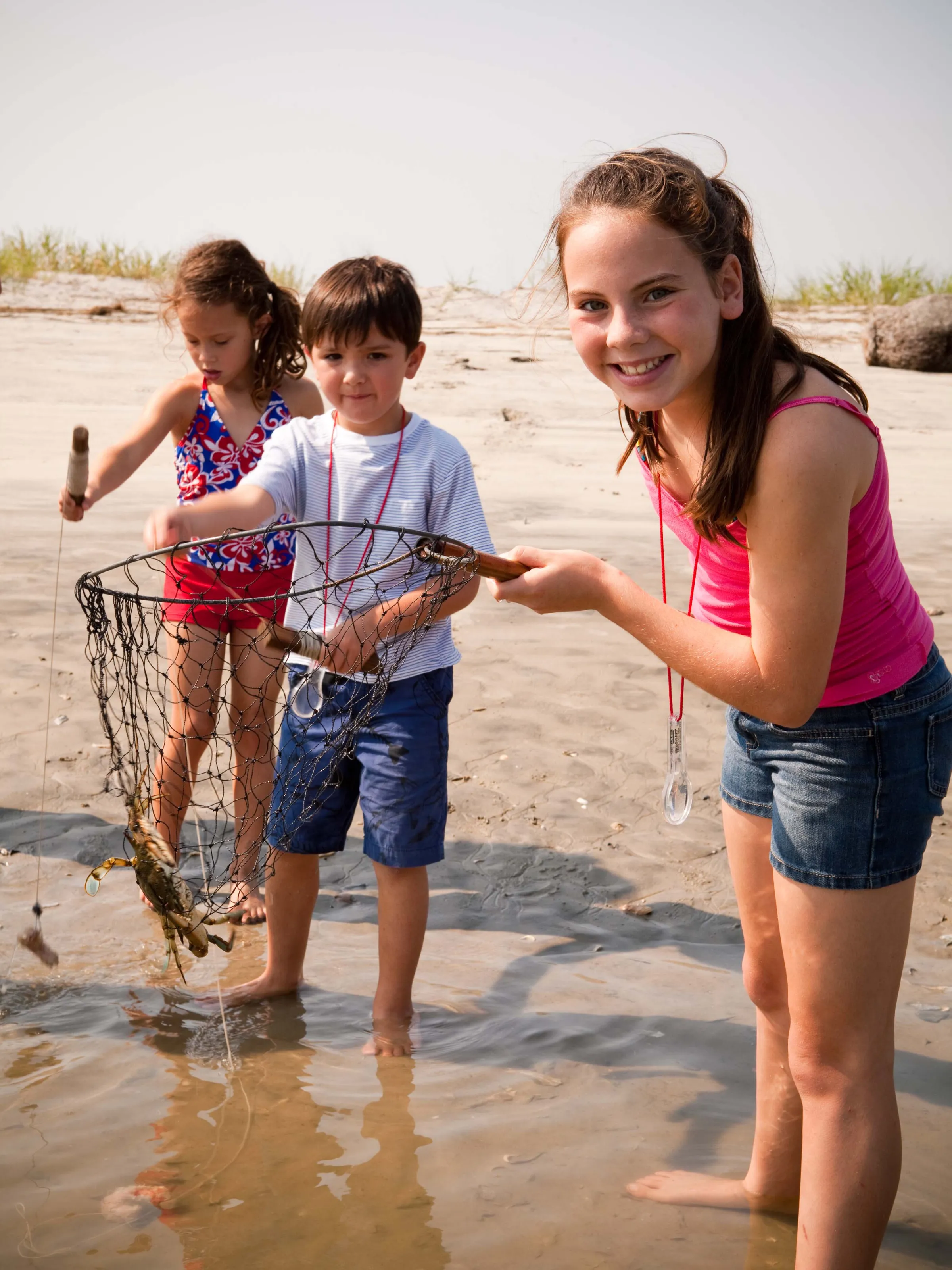Kids catching crabs in a cast net