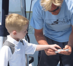 Child touching a fish