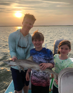 people holding a shark