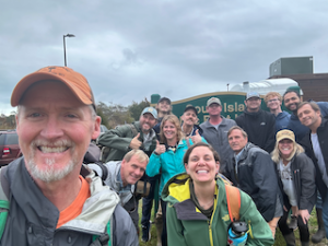 a group of people standing in front of a crowd posing for the camera
