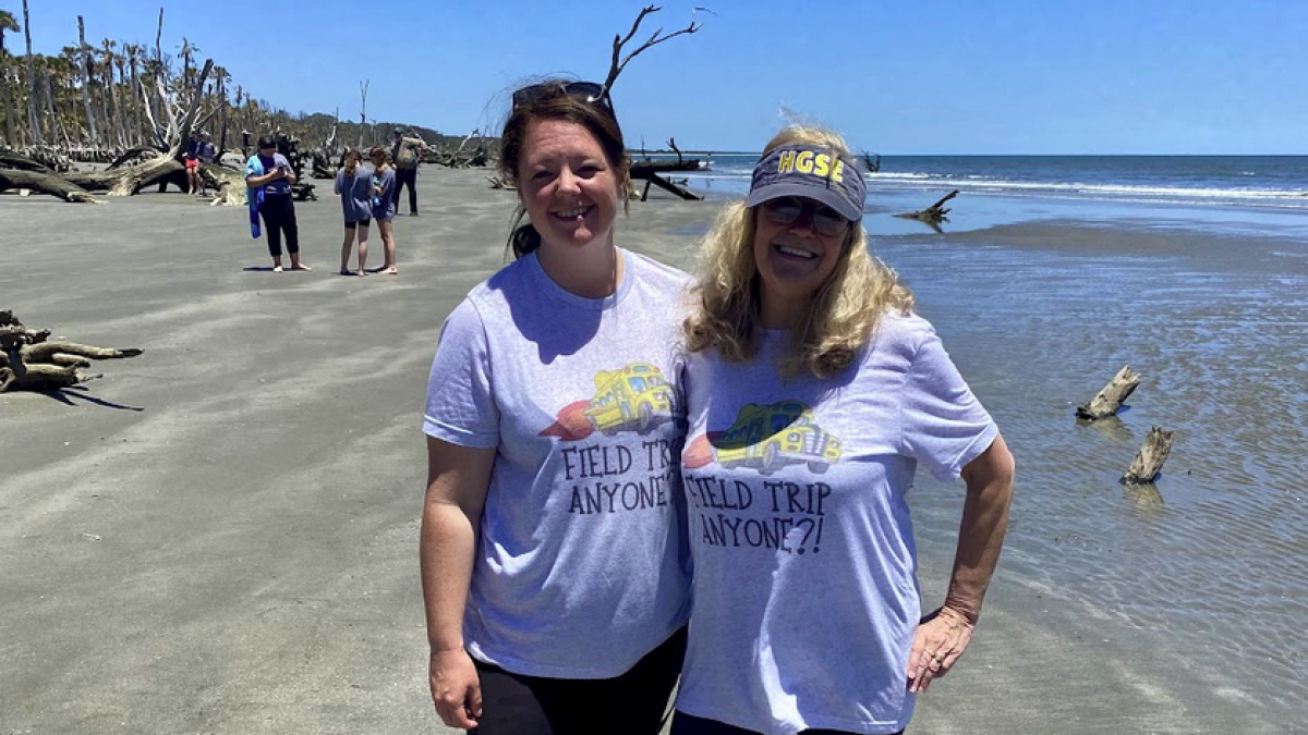 a couple of people that are standing in the water