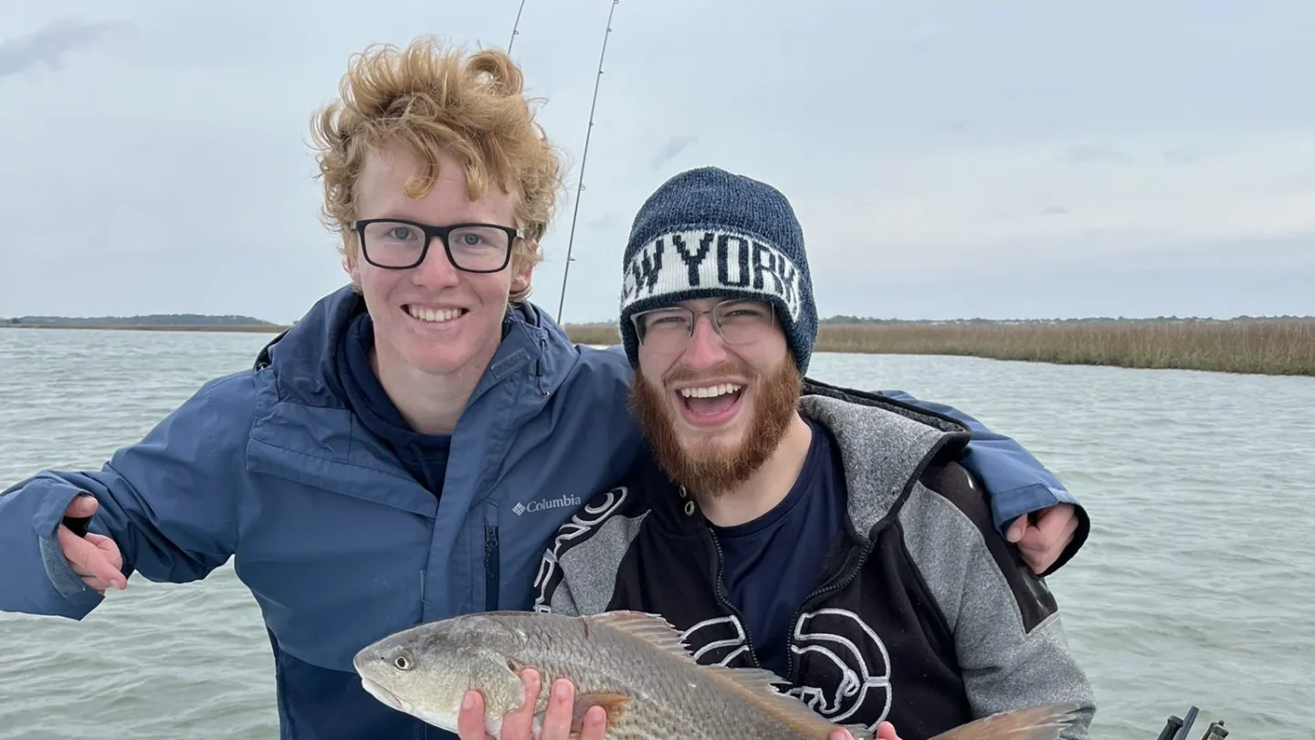a person holding a fish in the water