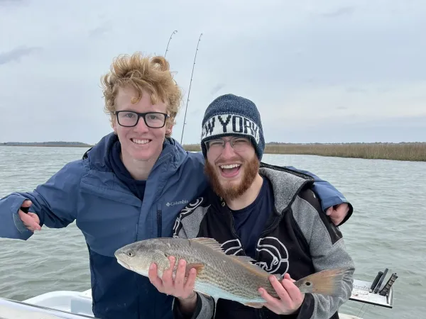 a person holding a fish in the water