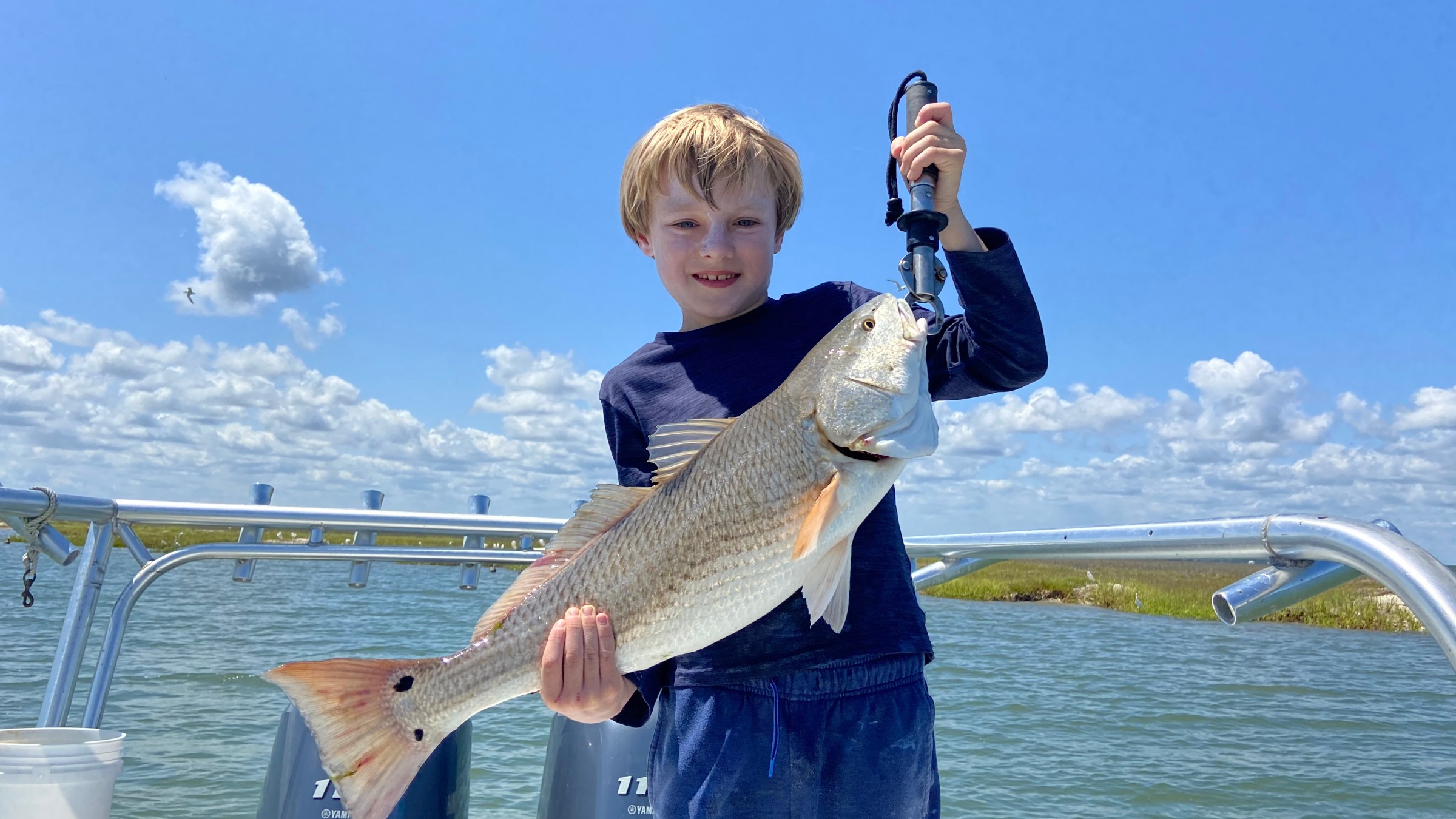 a person holding a fish in the water