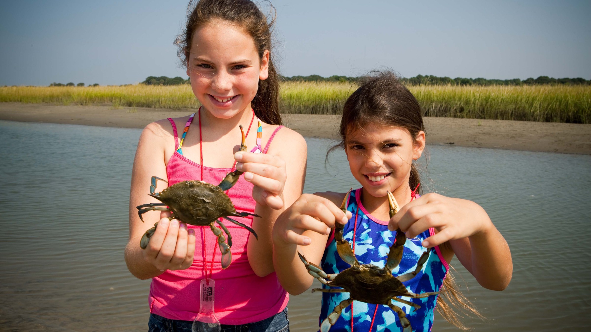 a person holding a baby in a body of water