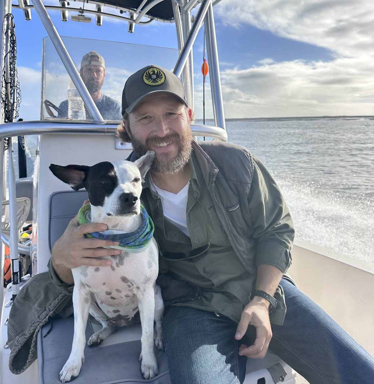 a man and a dog sitting on a boat
