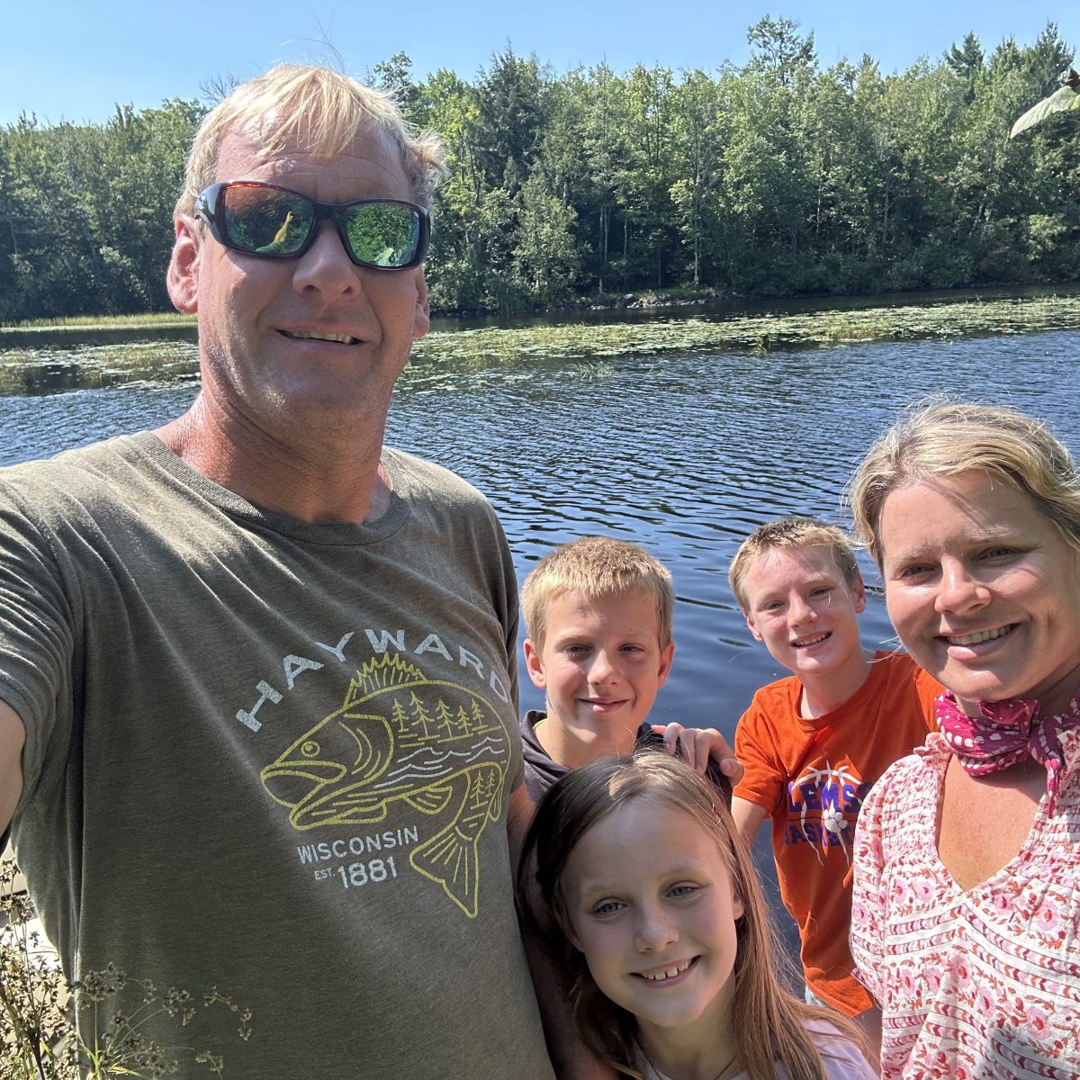 a man standing next to a body of water